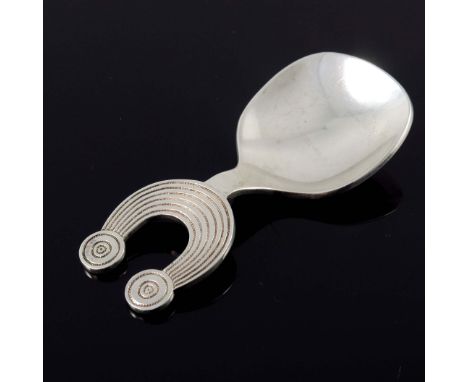 An Irish Modernist silver caddy spoon, Thomas O'Connor and Sons, Dublin 1973, the handle in the form of a Celtic torque, 8cm 