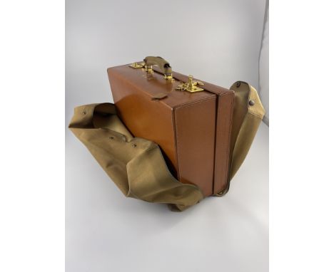 A George VI Mappin &amp; Webb dressing case, monogrammed canvas foul weather cover, tan leather case with brass J.T. Needs/la