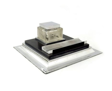 An Art Deco chrome, ebonised and etched glass ink stand, square section with geometric cuboid inkwell, and sectional trough p