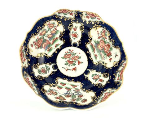 A Worcester scale blue bowl, square mark, circa 1770, double ogee form with serpentine rim, painted with chrysanthemums in th