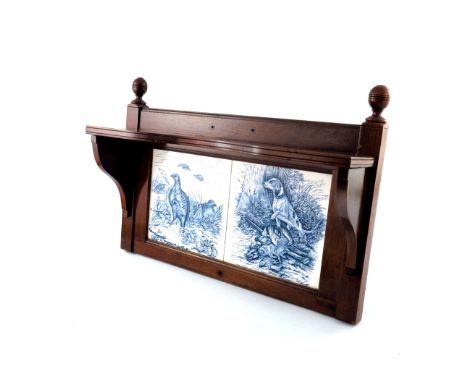 A mahogany Aesthetic Movement wall mounted hall shelf, circa 1880, ring turned finials, inset twin ceramic tiles of sporting 