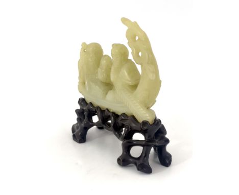 A Chinese pale jade model of a junk, containing a man with paddle and an elder holding a fish and a staff, 11.5cm wide, on a 