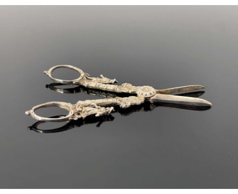 A pair of cast white metal grape scissors, probably Dutch, circa 1890, in the Rococo style, modelled with two pastoral figure