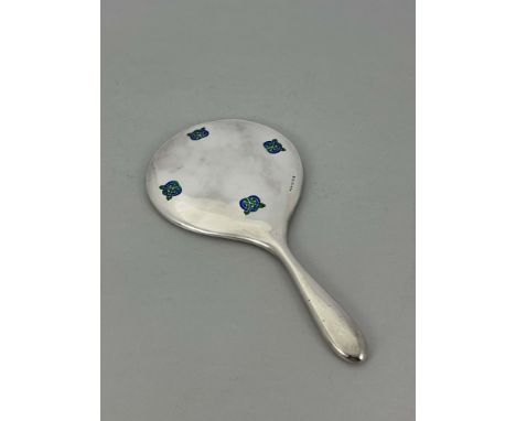 Archibald Knox for Liberty and Co., an Arts and Crafts silver and enamelled hand mirror, Birmingham 1909, decorated with four