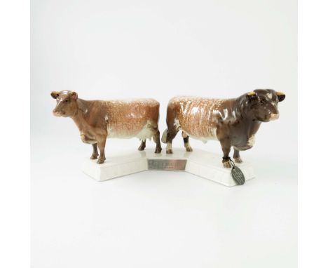 A Beswick cattle group of a Dairy Short Horn cow and bull, model nos 1863 and 1504, mounted on a plinth base with white metal