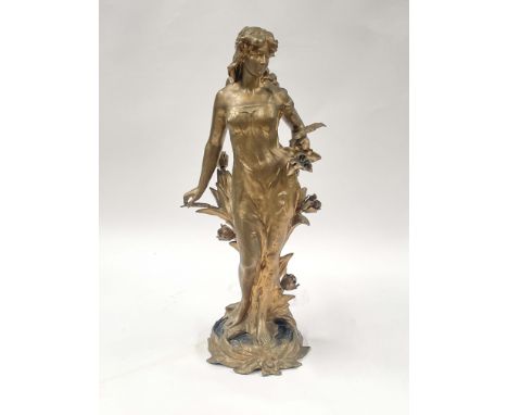 An Art Nouveau gilt metal electric table lamp, circa 1910, in the form of a standing classically draped maiden beside a branc
