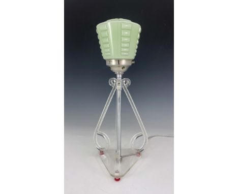 An Art Deco lucite table lamp, three scroll end bracket supports, on triangular base