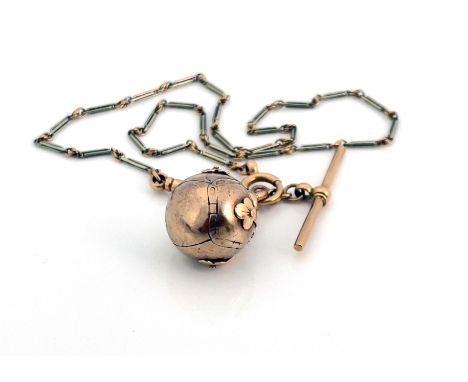 A yellow metal masonic metamorphic cross pendant, folding to form a sphere, the internal pyramidal surfaces engraved with mas