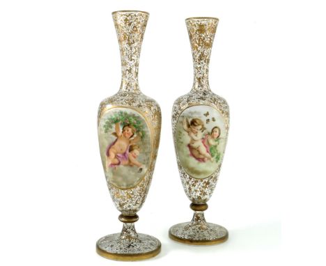 A pair of 19th century Bohemian cased glass portrait vases, shouldered pedestal urn form, colourless with gilt foliate scroll