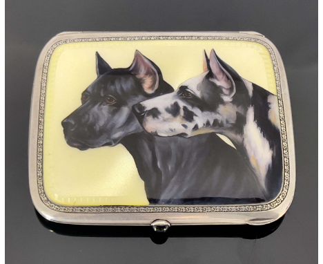 A silver and enamelled cigarette case, the lid painted with two dogs, on yellow guilloche enamel ground, within foliate borde