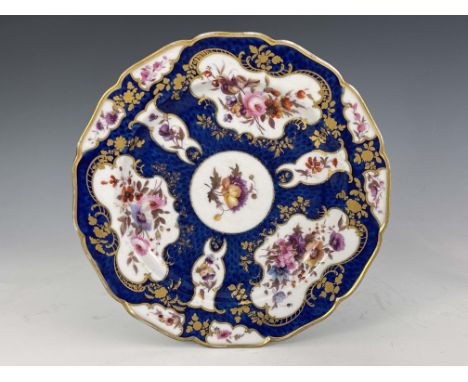 A Worcester Flight Barr and Barr scale blue plate, circa 1820, painted with floral bouquets in gilt cartouches, impressed mar