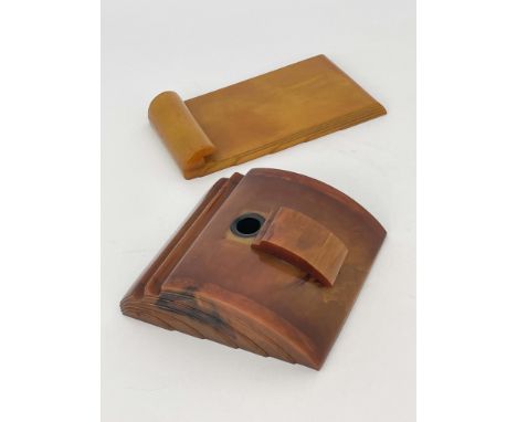 An Art Deco Carvercraft Bakelite inkwell and notepad holder, amber effect, stepped and fanned design, stamped mark to one, 22