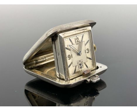 An Art Deco silver cased Sapho travel watch, SSM, Birmingham 1936, square form, cushioned and spring hinged lid, engine turne