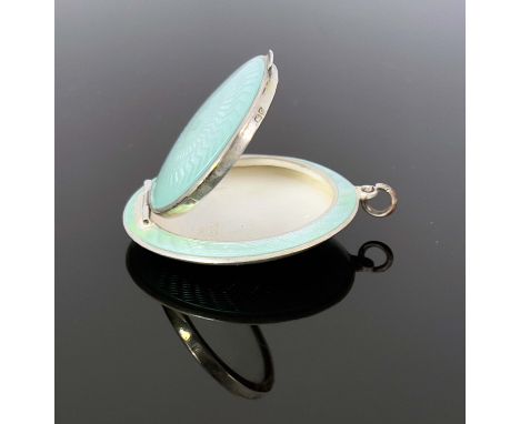 An Art Deco silver and enamelled pendant compact, Turner and Simpson, Birmingham 1927, circular lens form, each side with pal