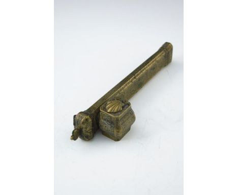 An Islamic brass scribe's inkwell, incorporating quill holder, 23cm long 