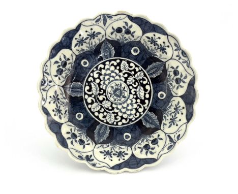 A Worcester blue and white plate, pseudo Chinese mark, circa 1775, painted in the Kangxi Lotus pattern, fluted and lobed rim,