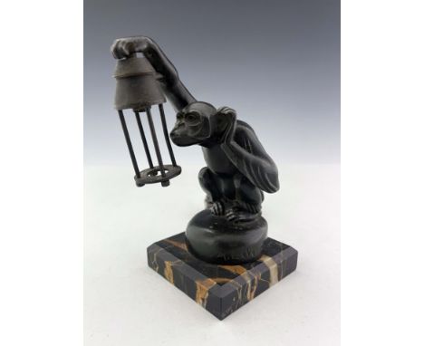 Max Le Verrier, Boubou, an Art Deco patinated art metal figural lamp or car mascot, circa 1930, modelled as a monkey holding 