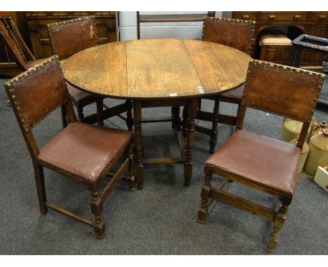 A set of four early 20th century oak brass studded leather upholstered dining chairs; an early 20th century oak gate leg dini