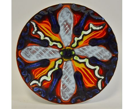 A Poole Delphis ware plate typically glazed in tones of blue, vulcan  red and aquamarine