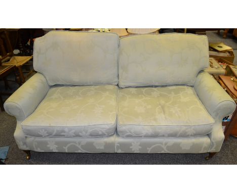 A contemporary two seater sofa, upholstered in Bird egg blue damask , turned mahogany legs, brass castors 