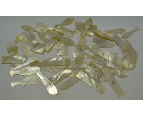 A quantity of Mother of Pearl gaming tokens
