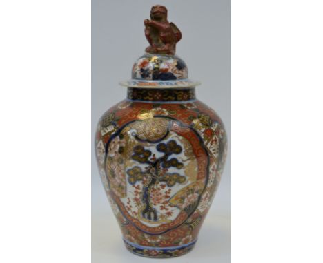 A Oriental temple jar and cover, decorated in the imari palate  with stylised flowers and foliage, monkey finial, 26cm high