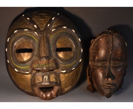 Tribal Art - a Yoruba hardwood mask, braided hair applied with cowry shells and colourful beads, traces of woven fabric to ch