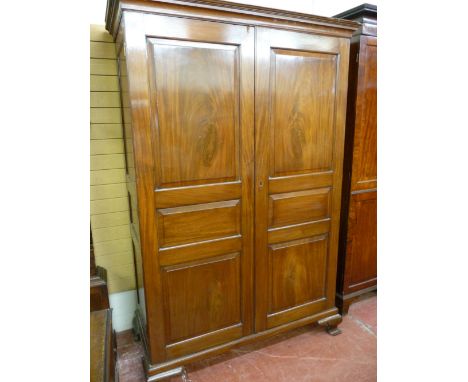 A VICTORIAN MAHOGANY CHAMFERED PANEL FRONT TWO DOOR WARDROBE, the twin three panel doors opening to reveal a lined interior w