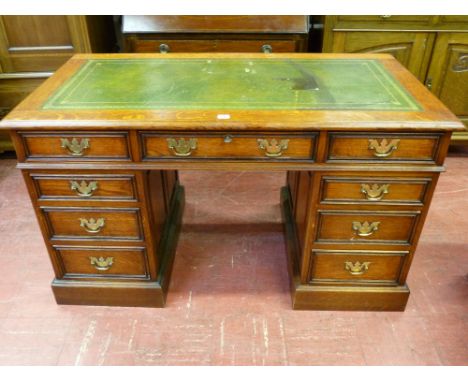 A GOOD OAK TWIN PEDESTAL DESK having a gilt tooled green leather insert over a three drawer frieze and twin three drawer pede