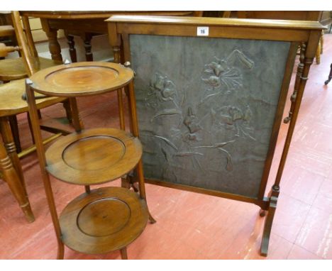AN ARTS & CRAFTS STYLE PEWTER FIRESCREEN and a mahogany three tier cakestand, the pewter screen having floral embossing on a 