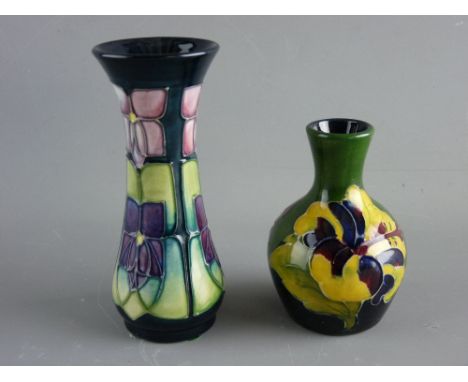 TWO MOORCROFT 'HIBISCUS' & 'VIOLET' VASES, 9.5 and 13 cms high respectively, decorated on tonal green/blue grounds with impre