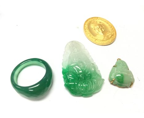 A collection of jade including a ring and pendants . Postage category A