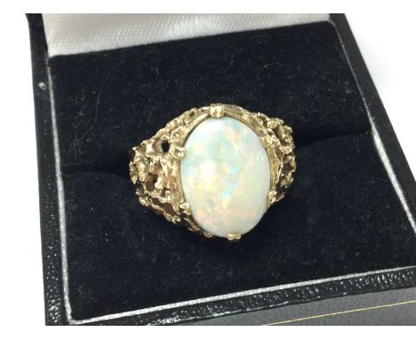 A 9ct gold opal ring, 4g total weight . Size N/O. Postage category A