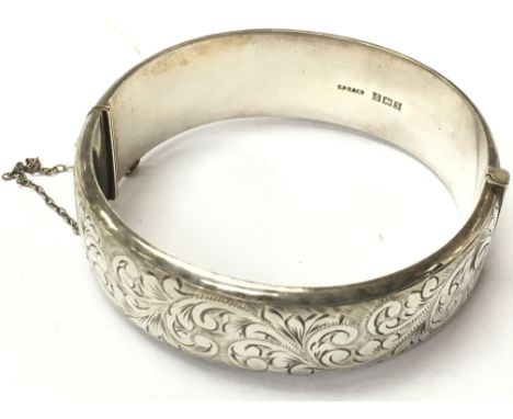 A Silver hallmarked bangle with engraved design. Postage category A