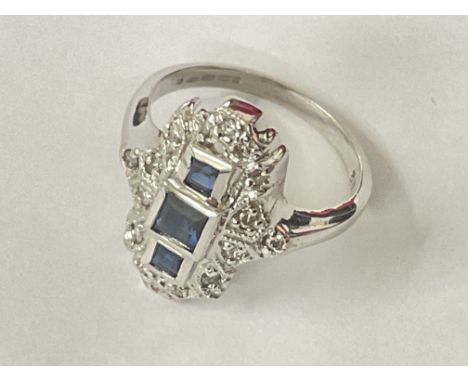 14ct white gold art deco style sapphire and diamond ring. Step cut sapphires 0.40ct approx. R/C diamonds 0.18ct approx. Posta