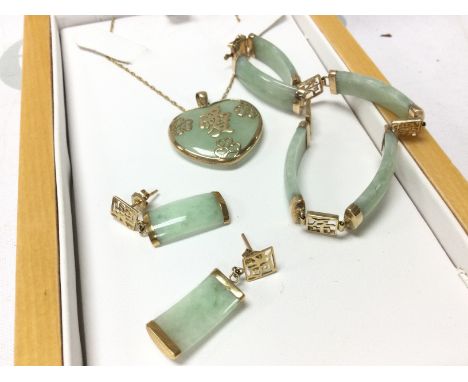 A 9ct gold and jade jewellery set. Postage category B