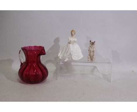 Royal Doulton - 2 x ceramic Royal Doulton figurines consisting of a standing Cairn Terrier dog and a Heather figure. Lot also