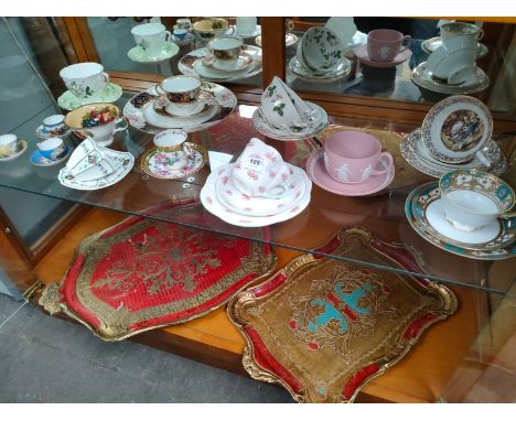 A shelf of Victorian cups and saucers includes Wedgwood pink jasper ware, Shelley together with 2 Victorian style serving tra