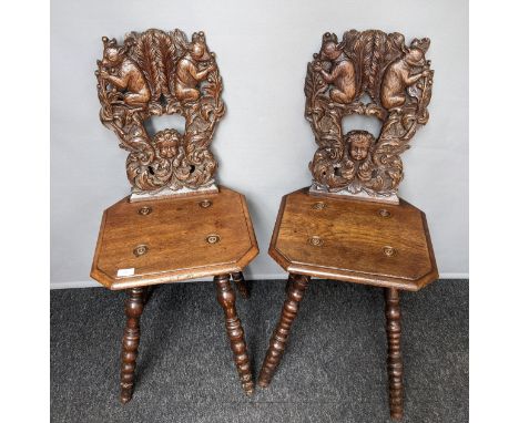 [Edward Holmes Baldock]PAIR OF OAK CHAIRS, 19TH CENTURY,The highly carved back with squirrels and child's face surrounded by 