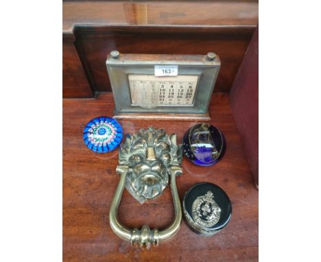 Antique desk callendar , brass lion old door knocker together with 3 paperweights . 