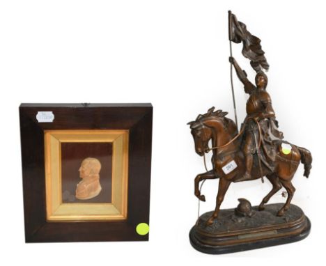 A 19th century miniature wax portrait relief of a gentleman together with a French patinated spelter equestrian figure titled