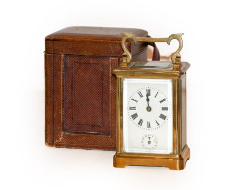 A brass carriage clock alarm timepiece in travelling case