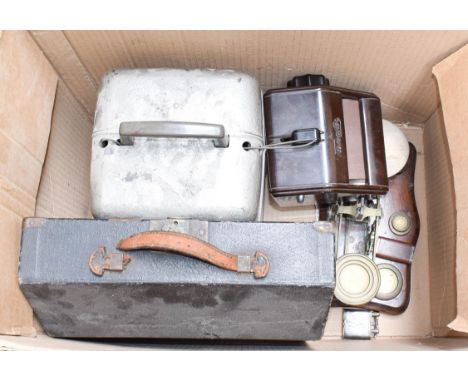 A box of assorted, including: a Bakelite tiemaster, a set of brass scales and weights, two lighters, a Bell &amp; Howell proj