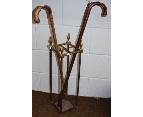 Two silver mounted measure sticks in a four-division brass stick stand