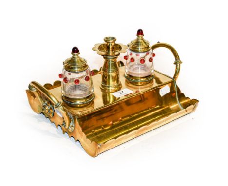 A Victorian brass Gothic revival desk stand in the manner of A W N Pugin, together with a pair of glass and ruby bottles, fla