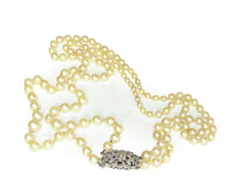 A graduated two row cultured pearl necklace knotted to a diamond set clasp, length 51cm .  Clasp stamped '9CT'. Gross weight 