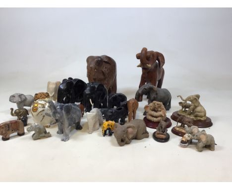 A large collection of elephants in a variety of materials, wood, stone, marble, ceramic, brass, resin. Includes elephants fro