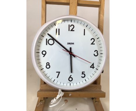 A Smiths electric wall clock in a white case with white face. Original instruction bookletW:35cm 
