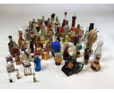 A collection of alcoholic miniatures including ceramic Beswick animals 