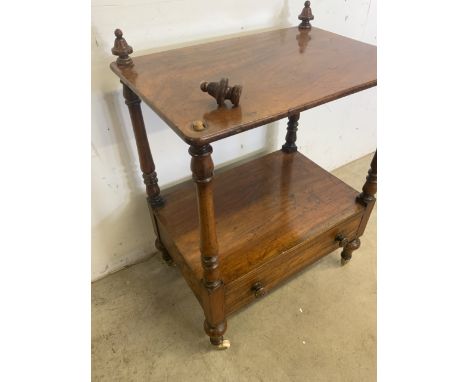 A mahogany Canterbury with drawer to base. Turned supports, brass and ceramic castors. W:57cm x D:38cm x H:77cm